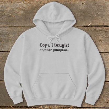 White hooded sweatshirt with black text "Oops, I bought another pumpkin...".
