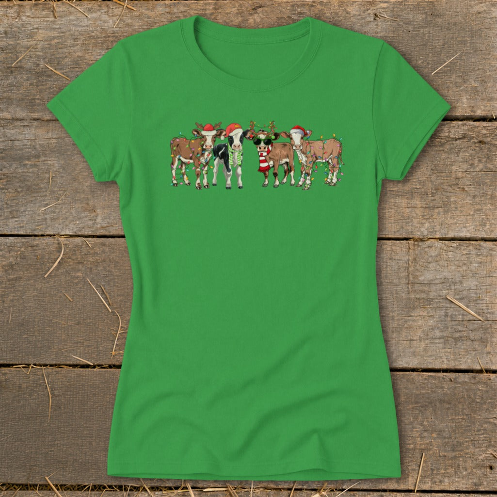 Green t-shirt with cartoon cows wearing Santa hats and Christmas lights.