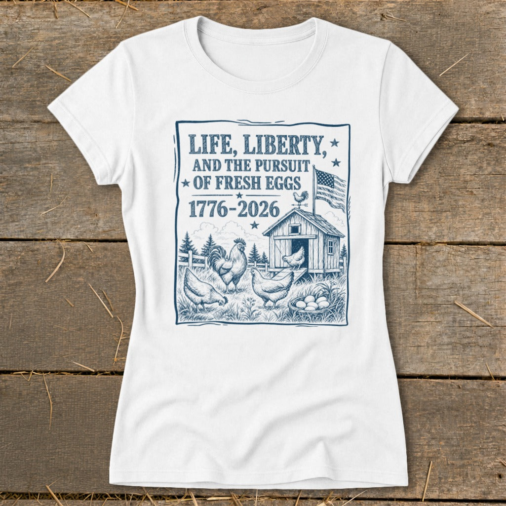 White t-shirt with blue graphic: "Life, Liberty, and the Pursuit of Fresh Eggs" and chickens.