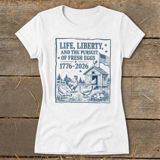 White t-shirt with blue graphic: "Life, Liberty, and the Pursuit of Fresh Eggs" and chickens.
