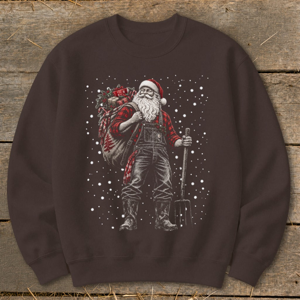 Santa Claus in overalls and plaid shirt carrying a sack and pitchfork.