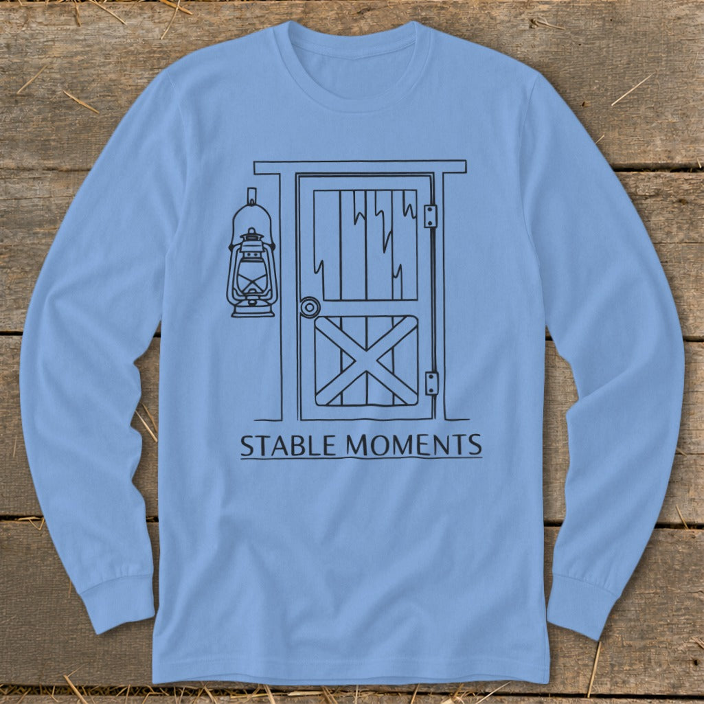 Light blue long sleeve shirt with line drawing of barn door and lantern.