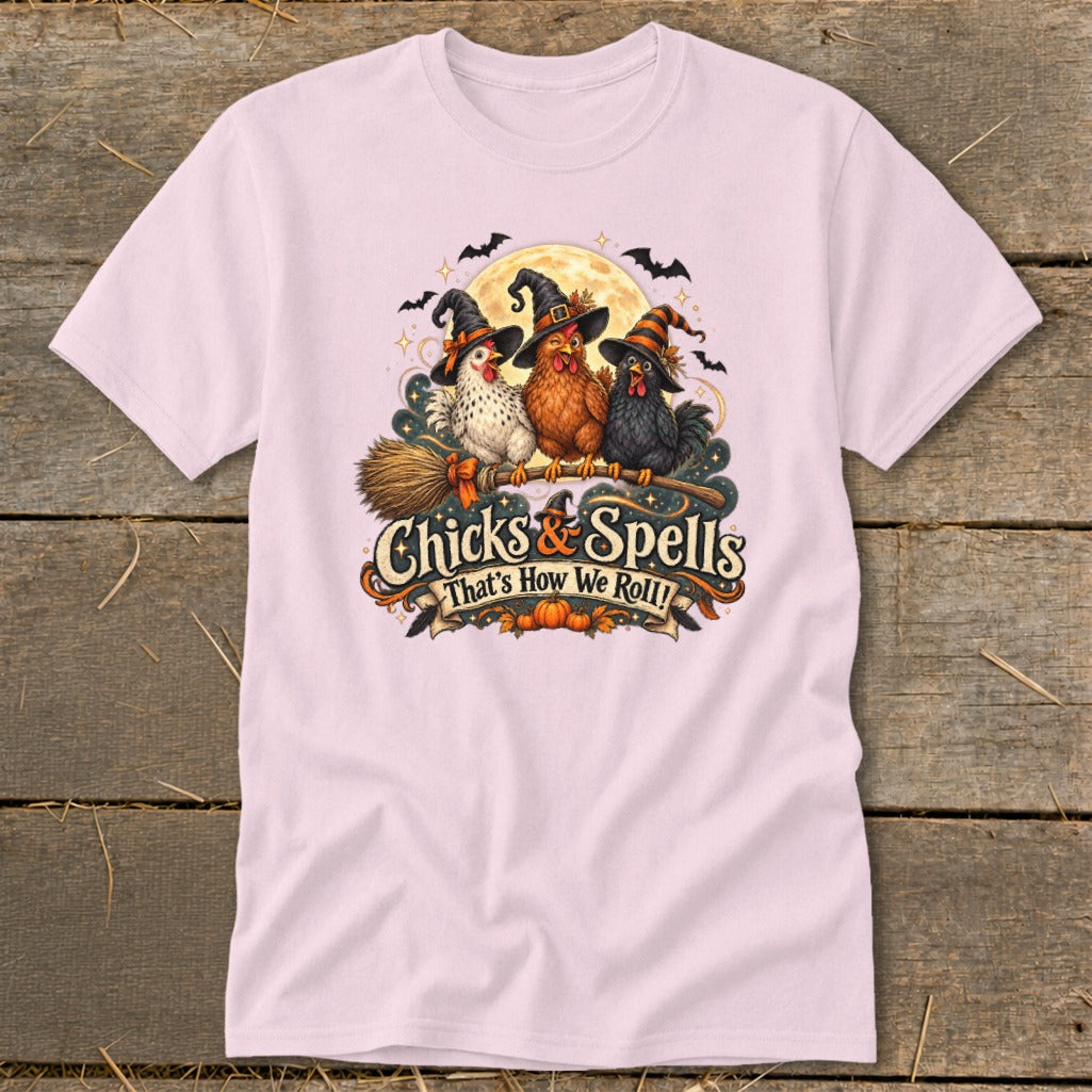 Three chickens in witch hats ride a broomstick under a full moon with "Chicks & Spells" text.