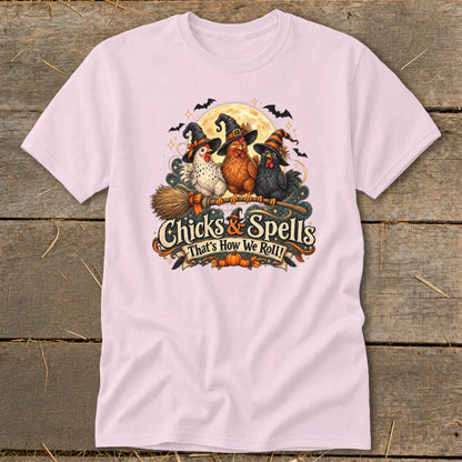 Three chickens in witch hats ride a broomstick under a full moon with "Chicks & Spells" text.