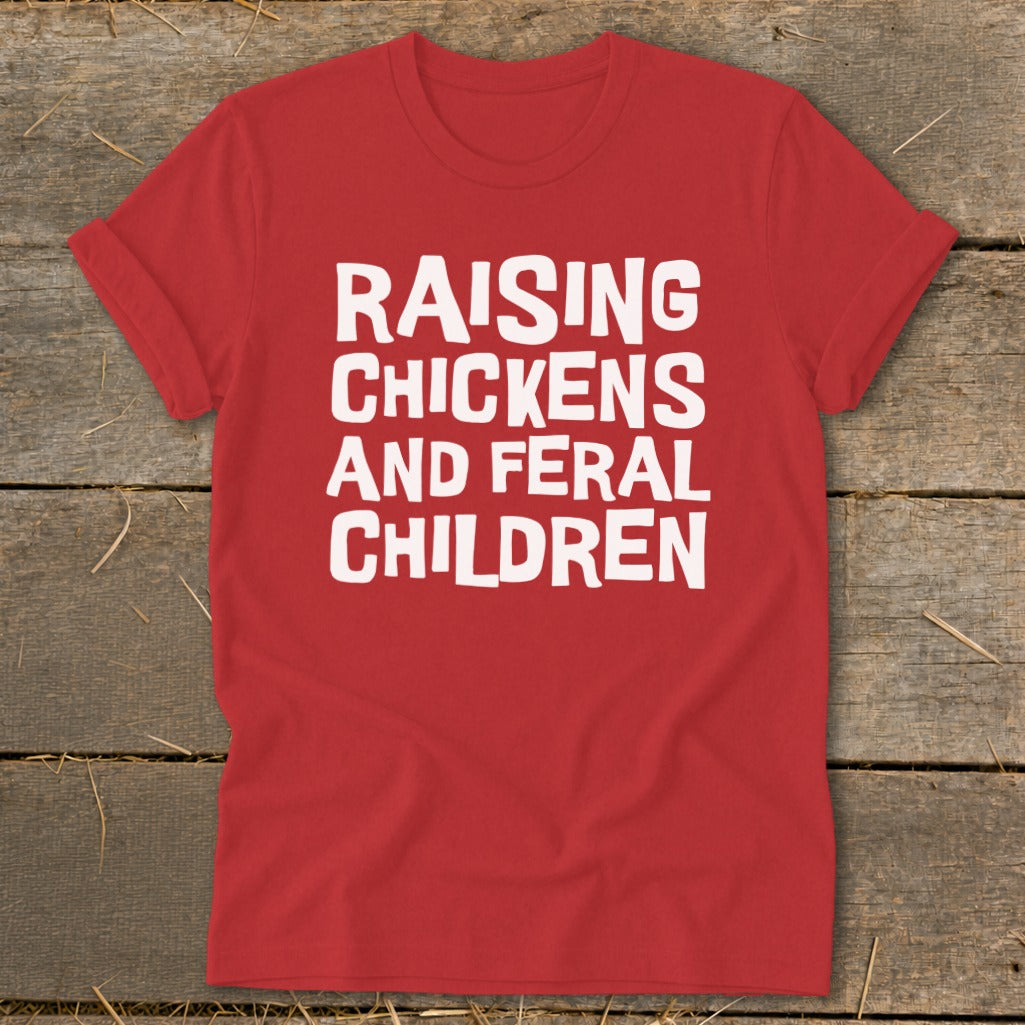 Red t-shirt with white text that reads "RAISING CHICKENS AND FERAL CHILDREN".