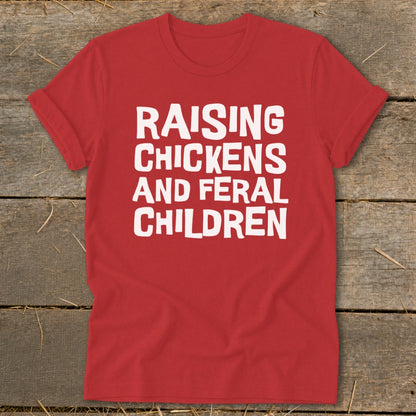 Red t-shirt with white text that reads "RAISING CHICKENS AND FERAL CHILDREN".