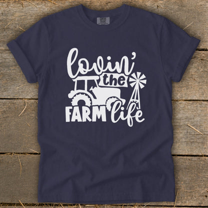 Navy t-shirt with white graphic that reads "lovin' the FARM life" and features a tractor and windmill.
