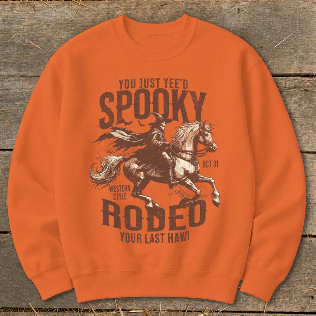 Orange sweatshirt with "You Just Yee'd Spooky Rodeo Your Last Haw!" Halloween graphic.