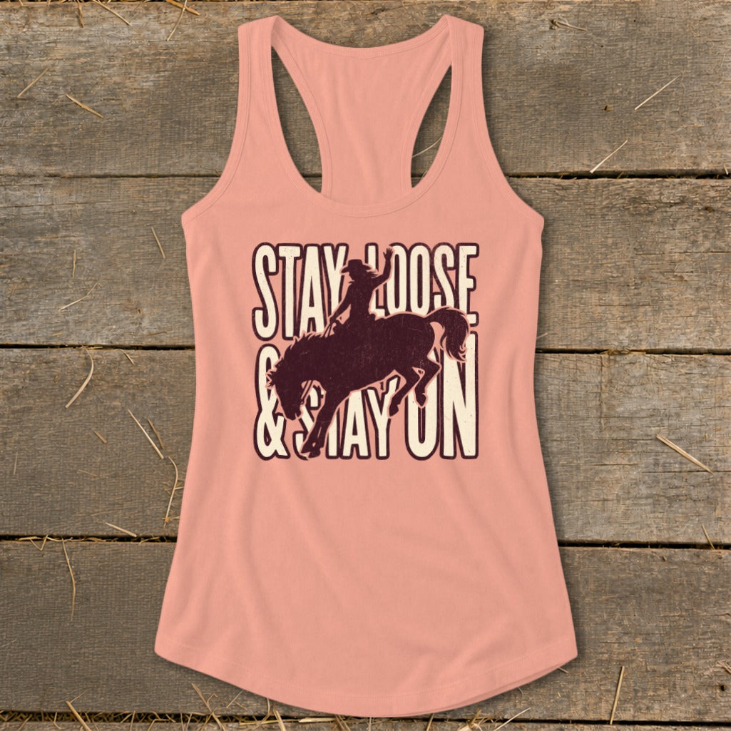 Peach tank top with "Stay Loose & Stay On" text and bronc rider graphic.