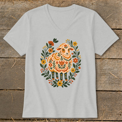 Light gray v-neck t-shirt with folk art sheep surrounded by floral wreath.