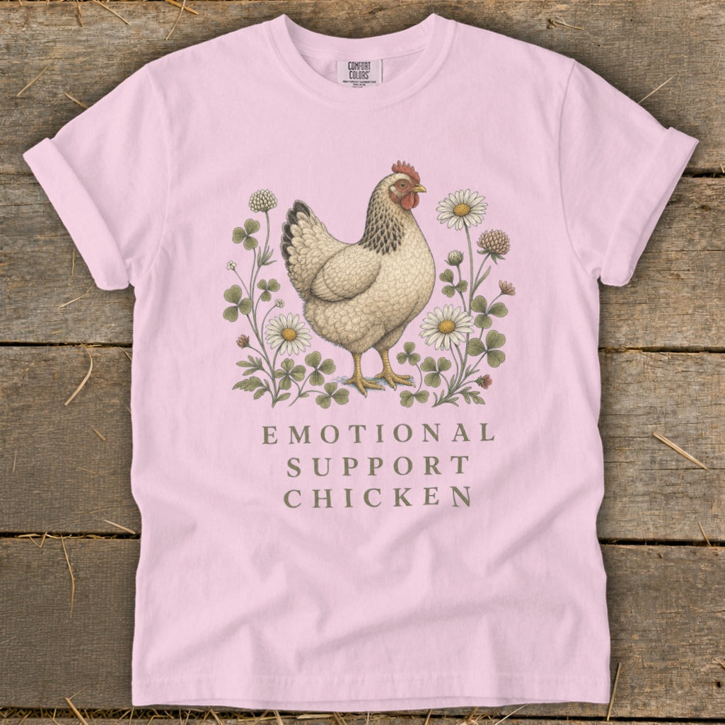 Pink t-shirt with a chicken surrounded by clover and daisies, text reads "EMOTIONAL SUPPORT CHICKEN".
