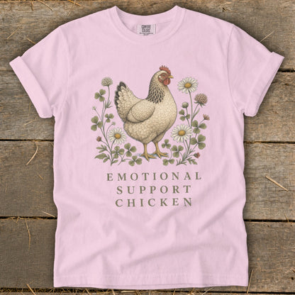 Pink t-shirt with a chicken surrounded by clover and daisies, text reads "EMOTIONAL SUPPORT CHICKEN".