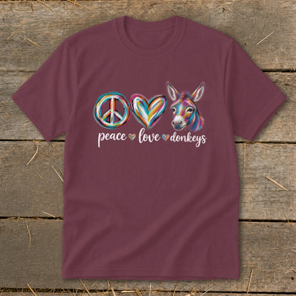Maroon t-shirt with peace, heart, and donkey graphic and text "peace love donkeys."
