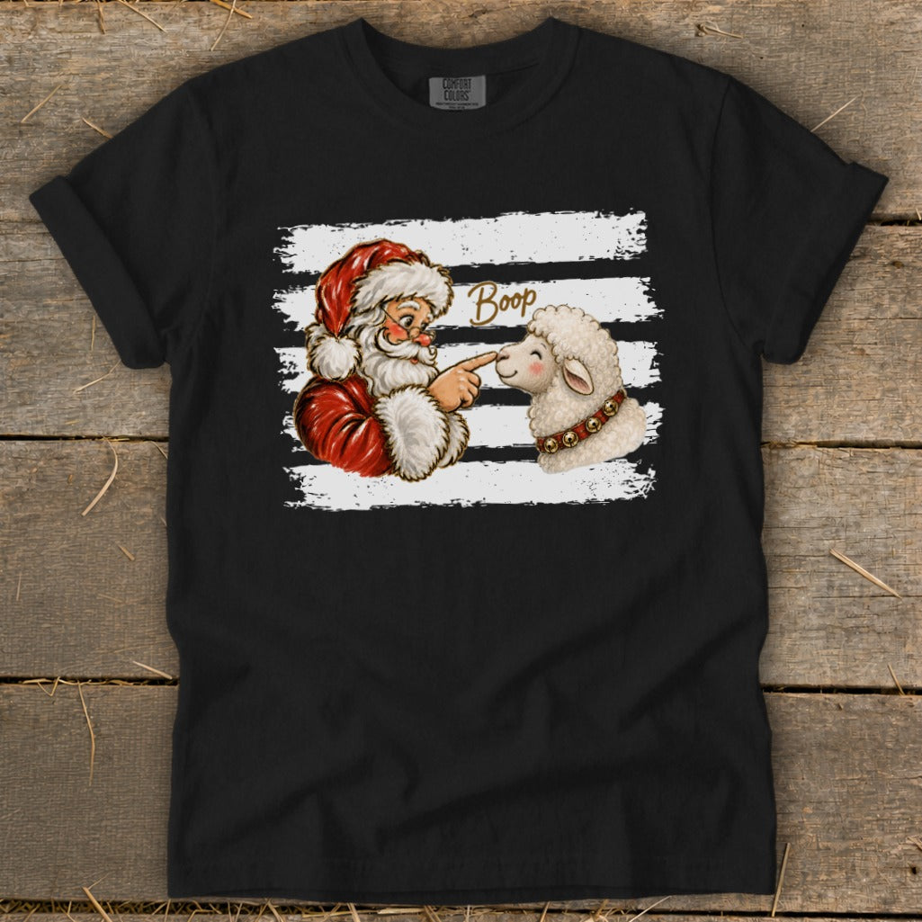 Santa touching a sheep's nose with the word "Boop" above it.