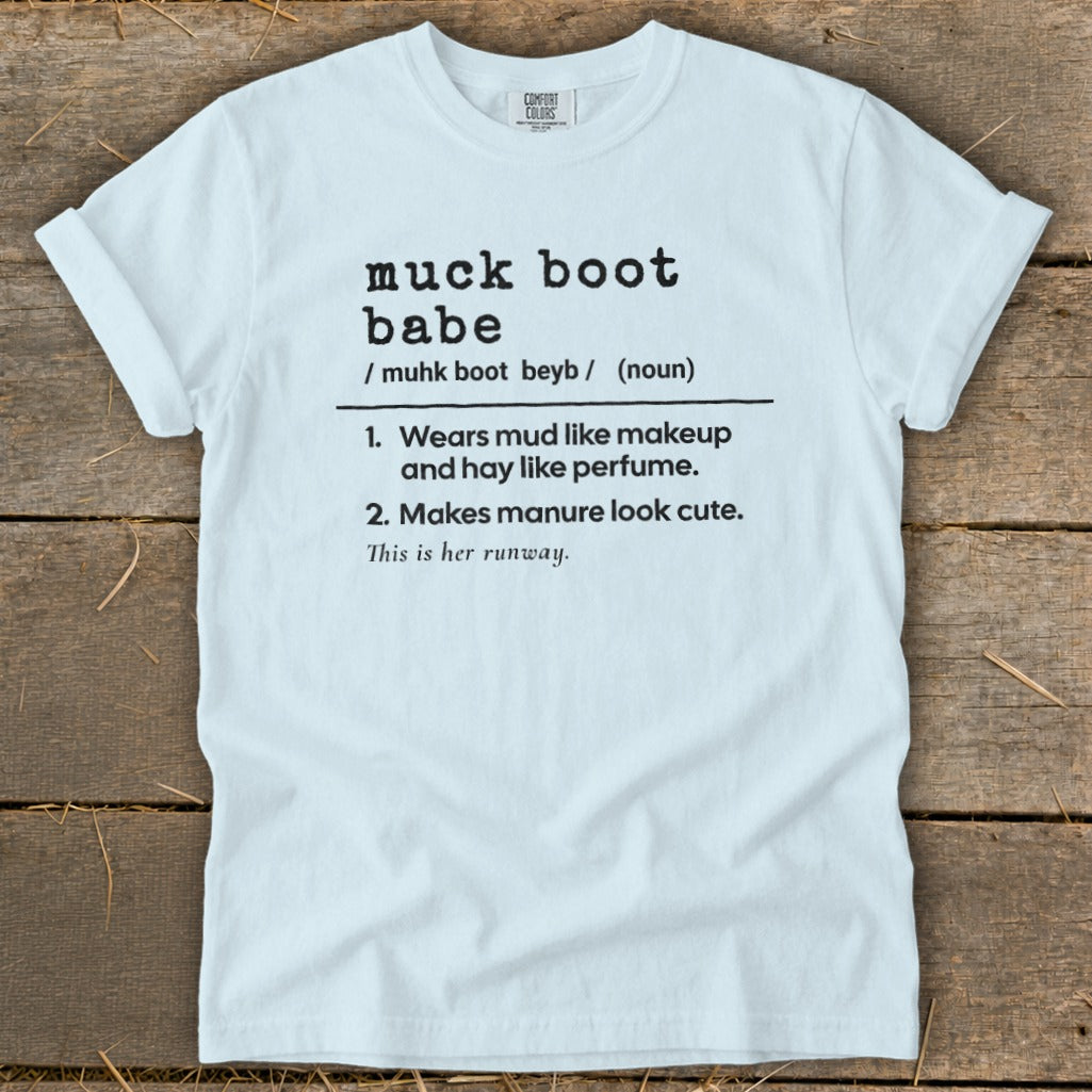 White t-shirt with "muck boot babe" definition printed in black text.