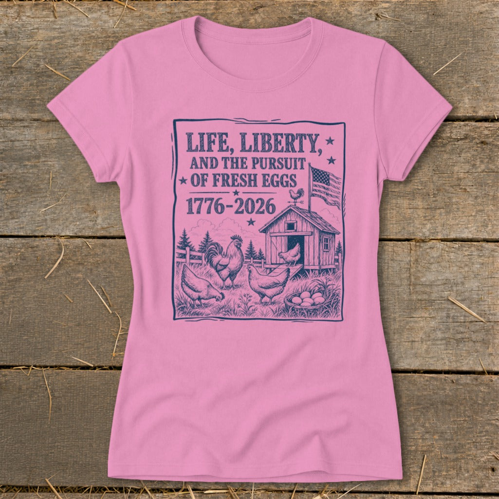 Pink t-shirt with "Life, Liberty, and the Pursuit of Fresh Eggs 1776-2026" graphic.