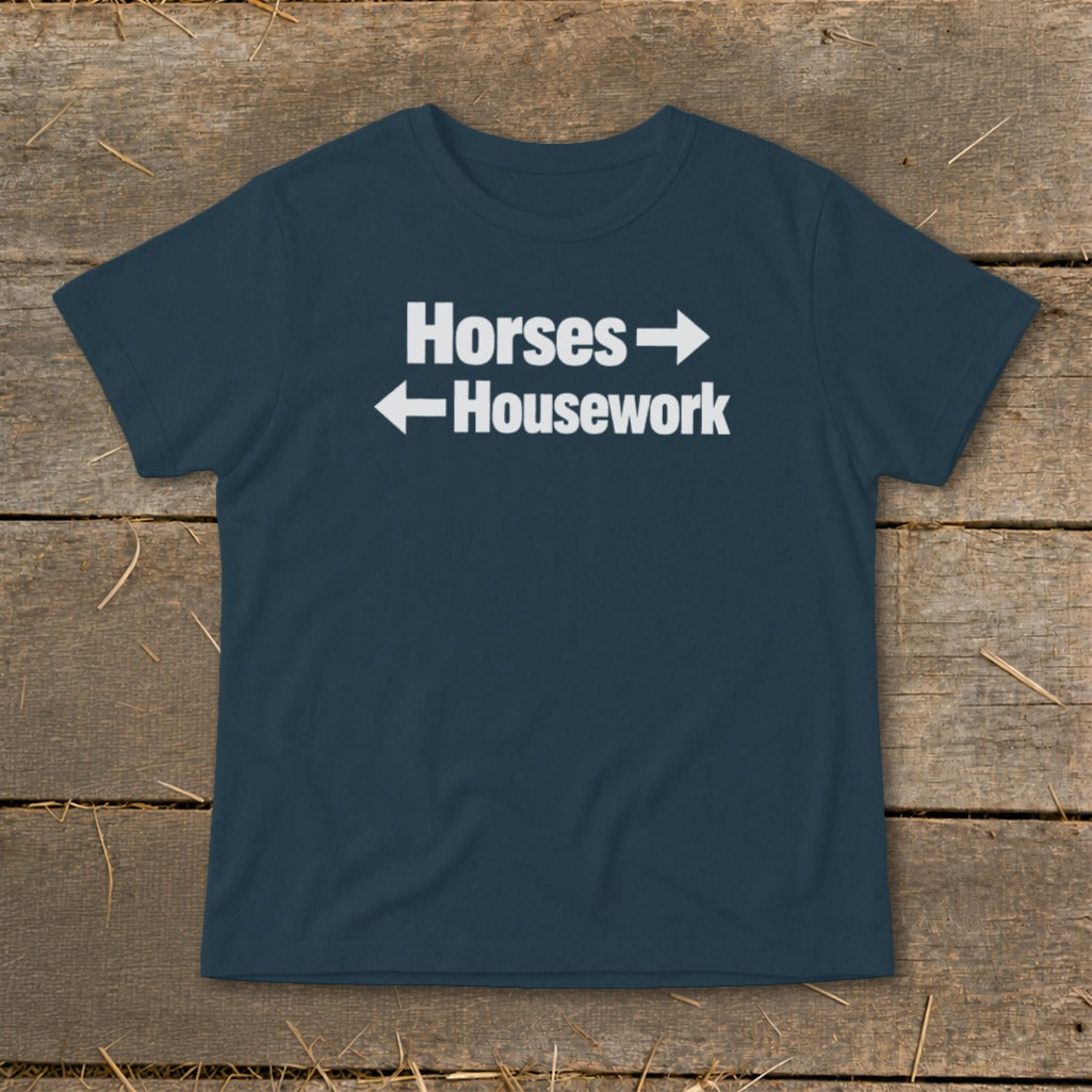 Dark blue t-shirt featuring the white text Horses with right arrow above Housework with left arrow.