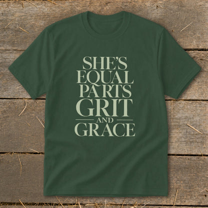 Green t-shirt with text "SHE'S EQUAL PARTS GRIT AND GRACE" in cream.