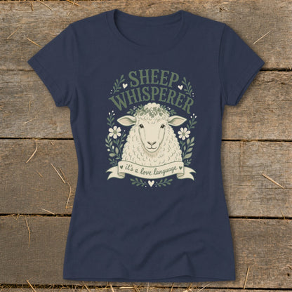 Navy t-shirt with "Sheep Whisperer" graphic and sheep wearing a flower crown.
