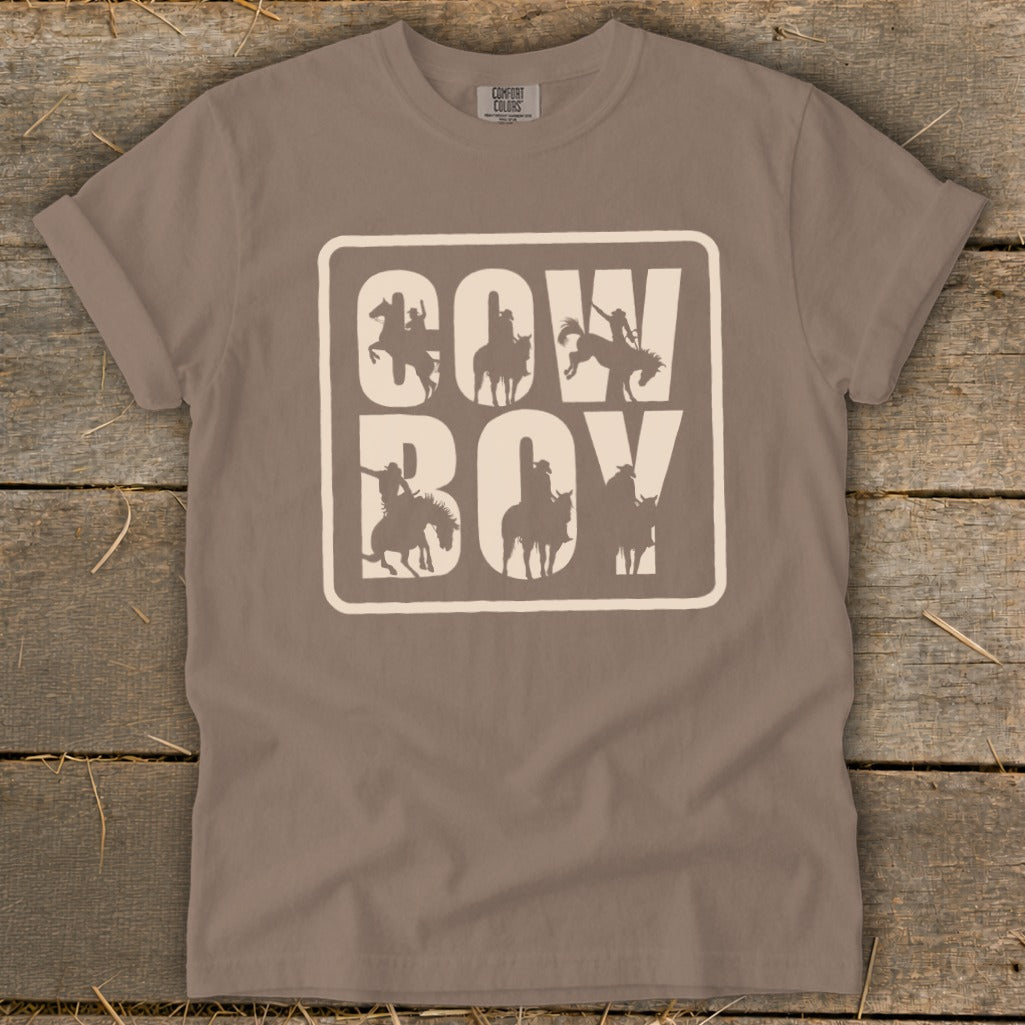 Brown t-shirt with white "Cowboy" text and silhouette images of cowboys on horses.