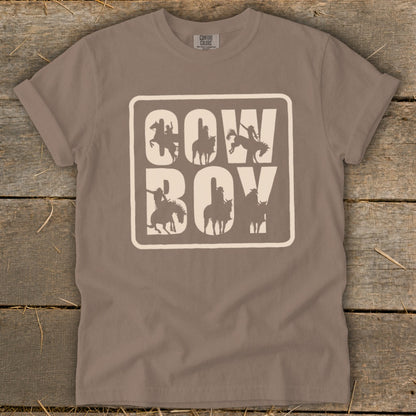 Brown t-shirt with white "Cowboy" text and silhouette images of cowboys on horses.