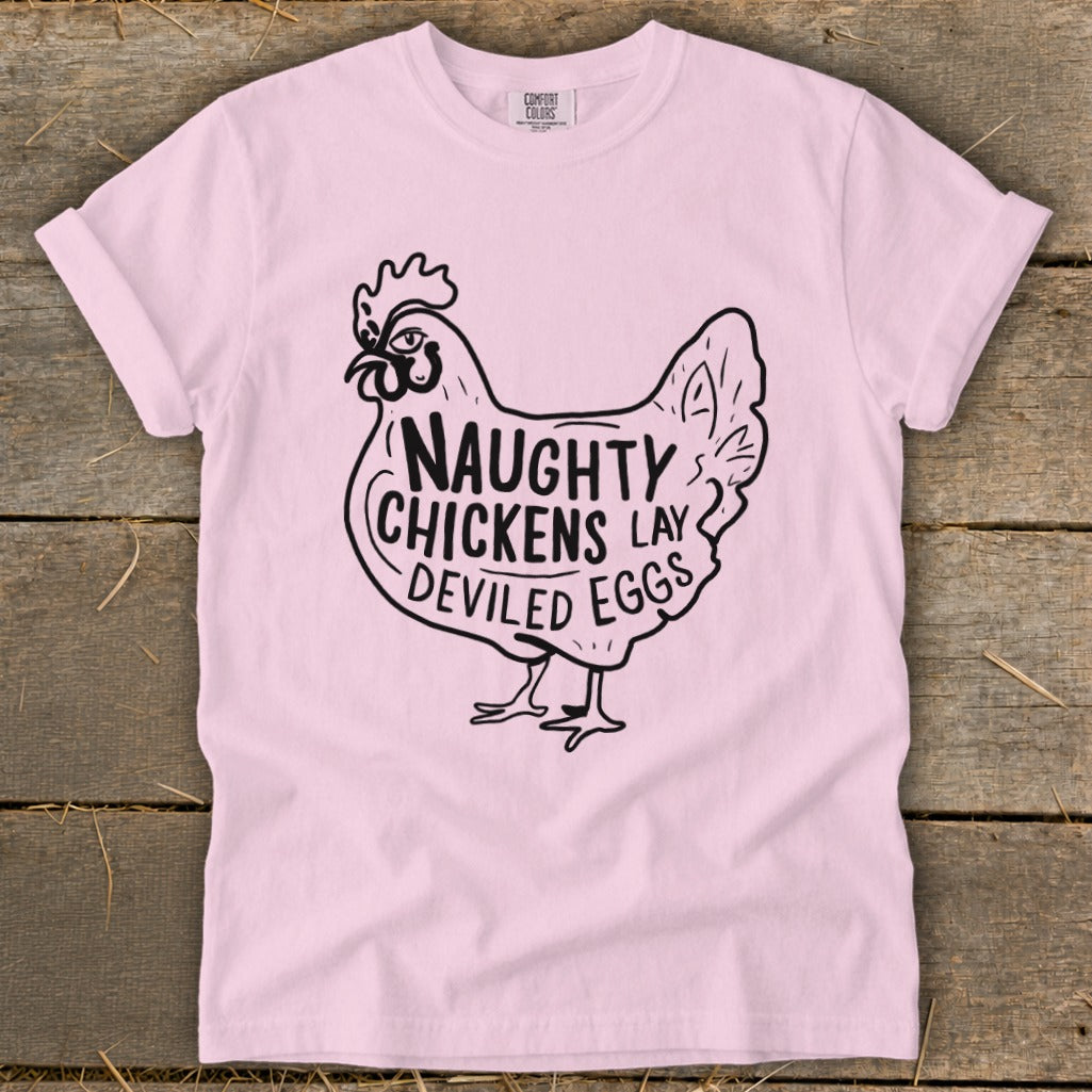 Pink t-shirt with black graphic of a chicken that says "Naughty Chickens Lay Deviled Eggs".