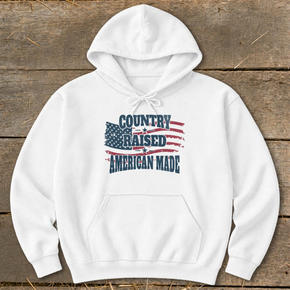White hoodie with "Country Raised American Made" text and American flag graphic.