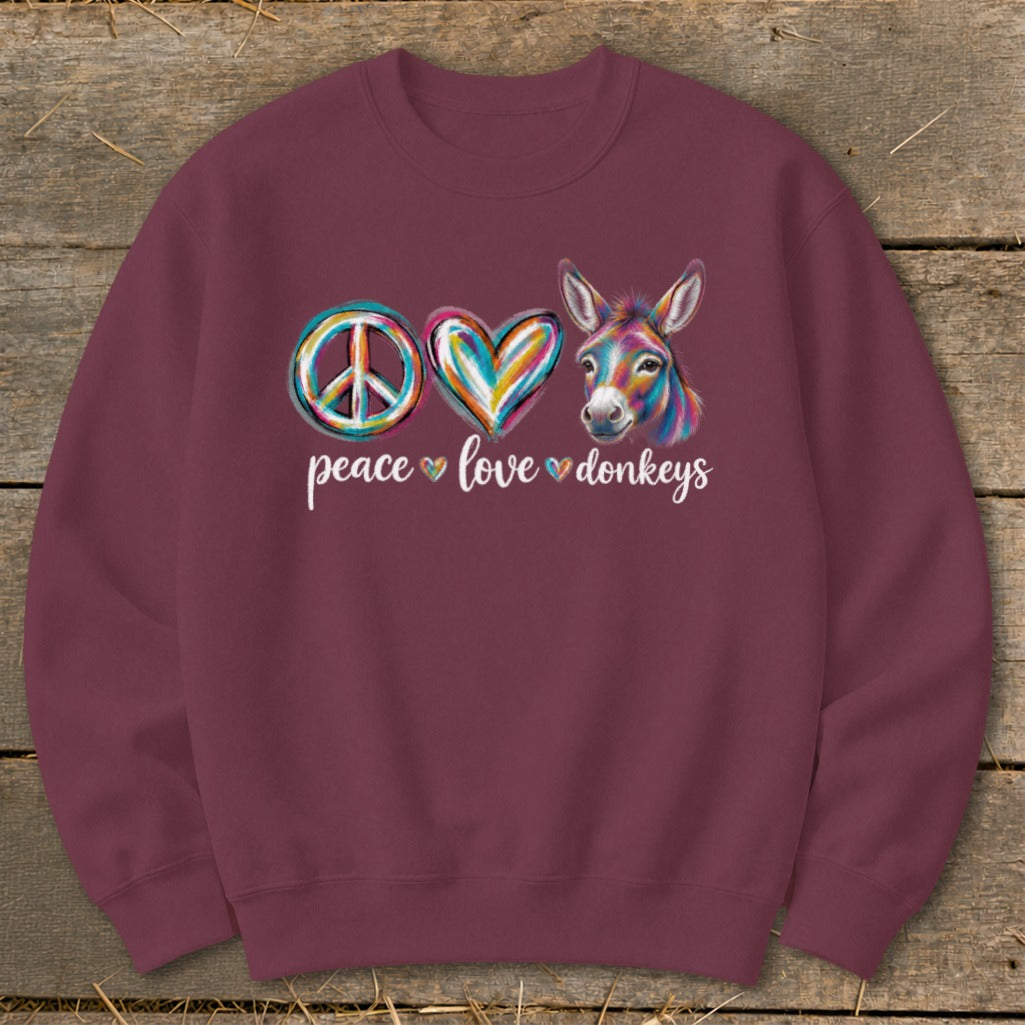 Burgundy sweatshirt with "peace love donkeys" and colorful graphics of a peace sign, heart, and donkey.