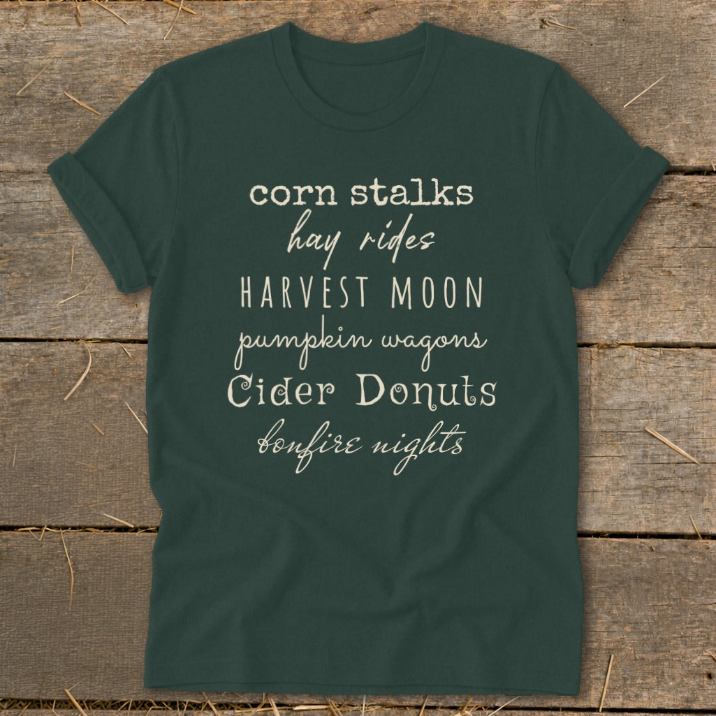 Dark green t-shirt with text listing fall activities.