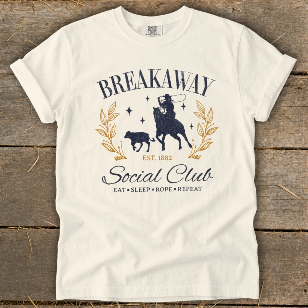 Cream t-shirt with "Breakaway Social Club" rodeo graphic and "Eat Sleep Rope Repeat" text.