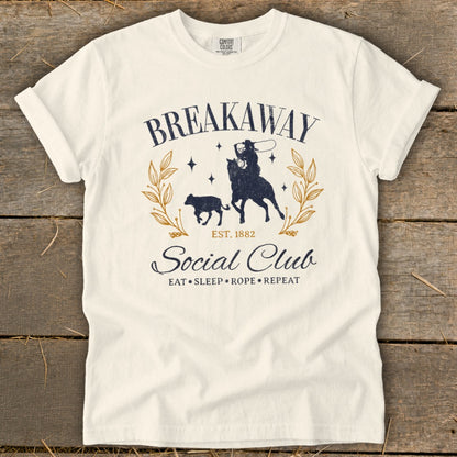 Cream t-shirt with "Breakaway Social Club" rodeo graphic and "Eat Sleep Rope Repeat" text.