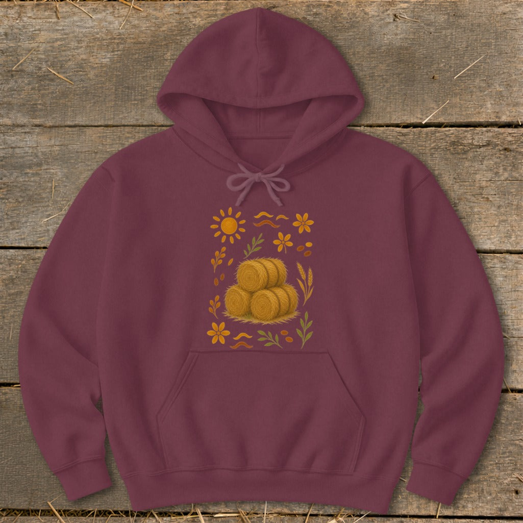 Maroon hoodie with a fall-themed graphic of hay bales, sun, and flowers.