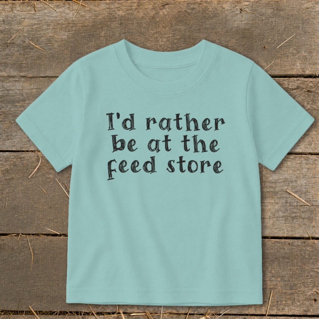 Teal t-shirt with "I'd rather be at the feed store" in black text.
