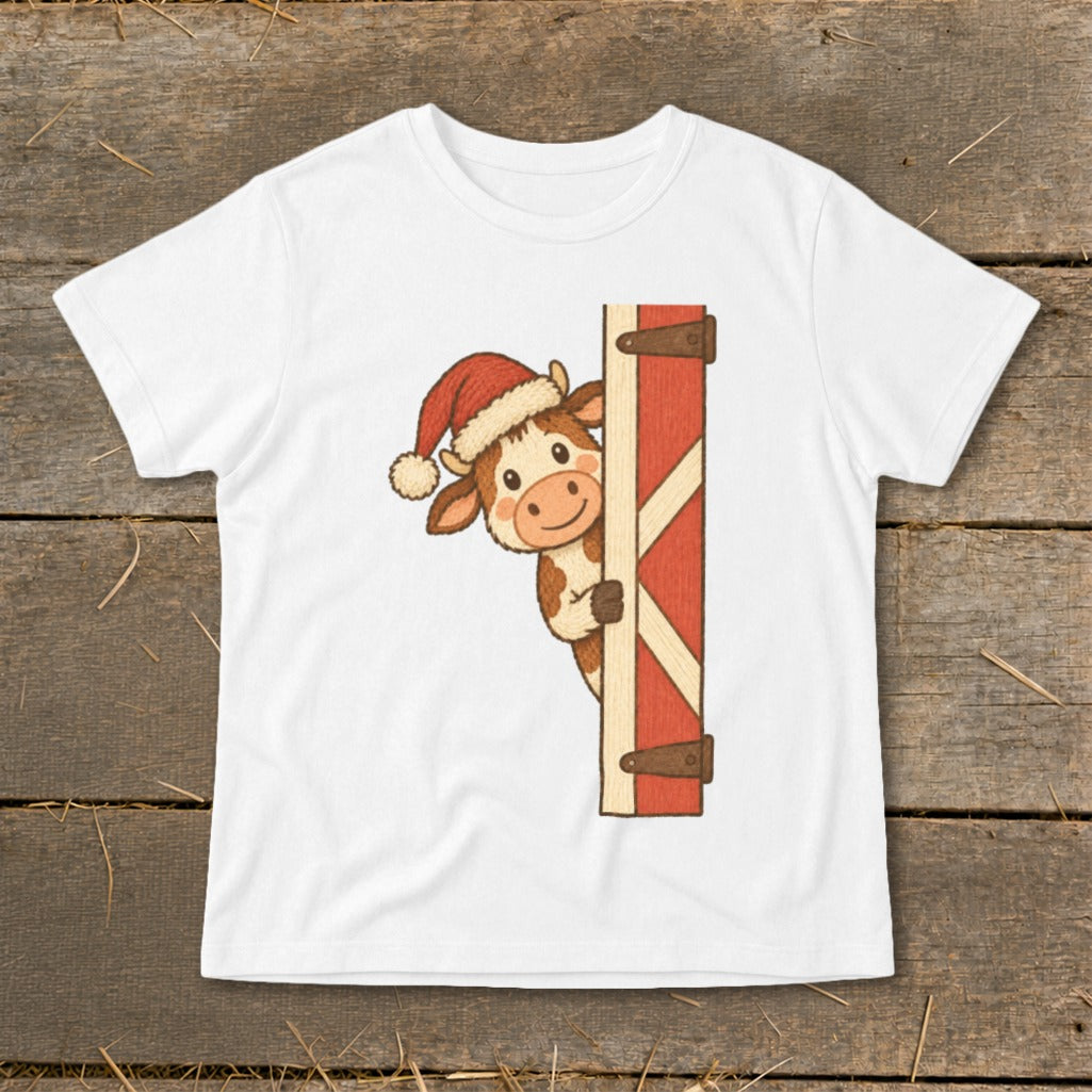 Cartoon cow wearing a Santa hat peeking around a barn door.