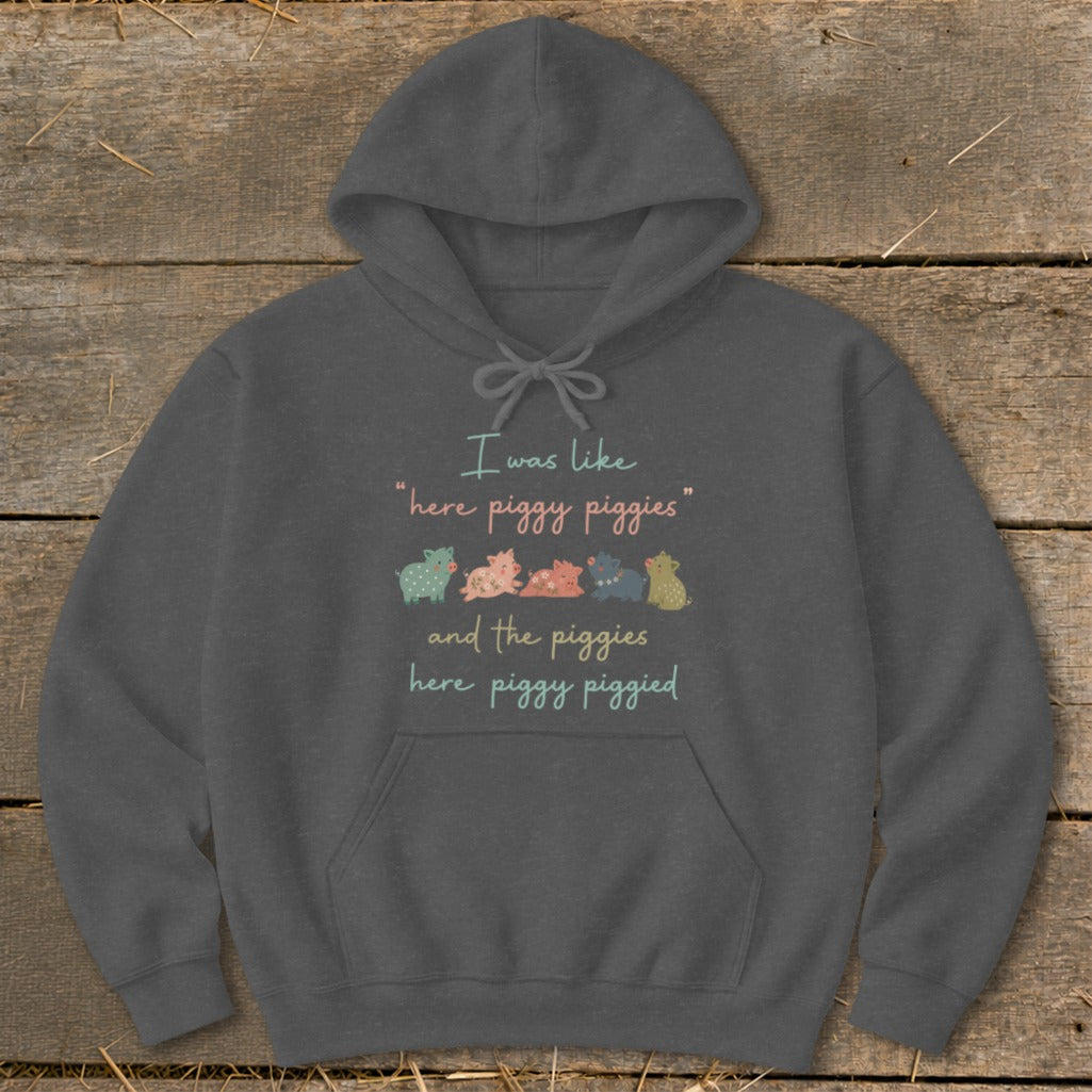 Dark grey hoodie with "I was like 'here piggy piggies' and the piggies here piggy piggied" and cartoon pigs.