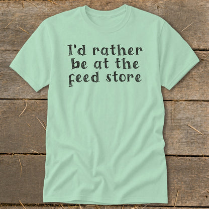 Light mint t-shirt with black text "I'd rather be at the feed store".