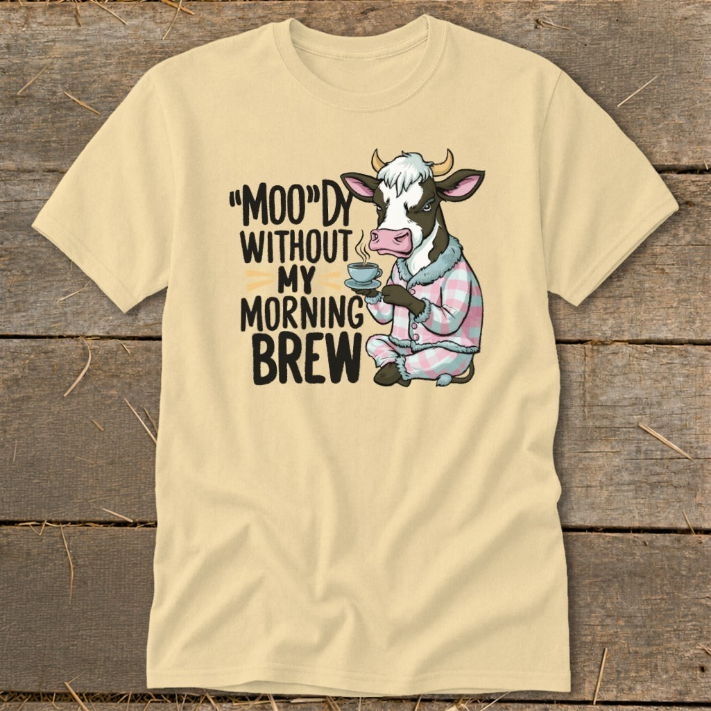 Cow in pajamas holding coffee, text "Moody Without My Morning Brew".