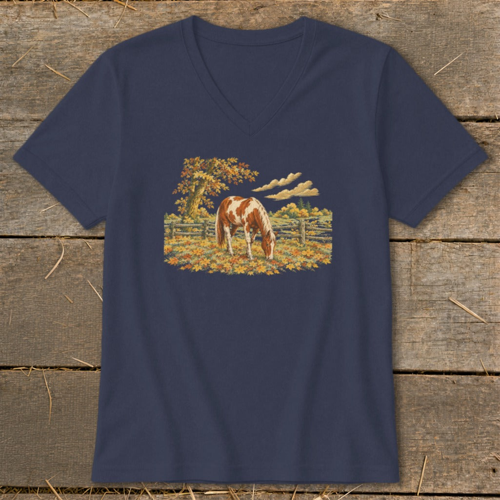 Navy t-shirt with a painting of a brown and white horse in a fall pasture.