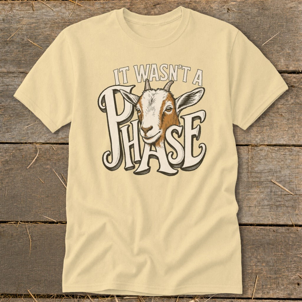 Light yellow t-shirt with goat head graphic and text "It Wasn't a Phase".