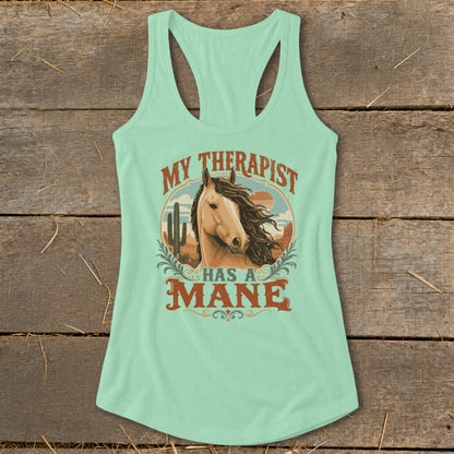 Light blue tank top with a horse and desert graphic and text "MY THERAPIST HAS A MANE".