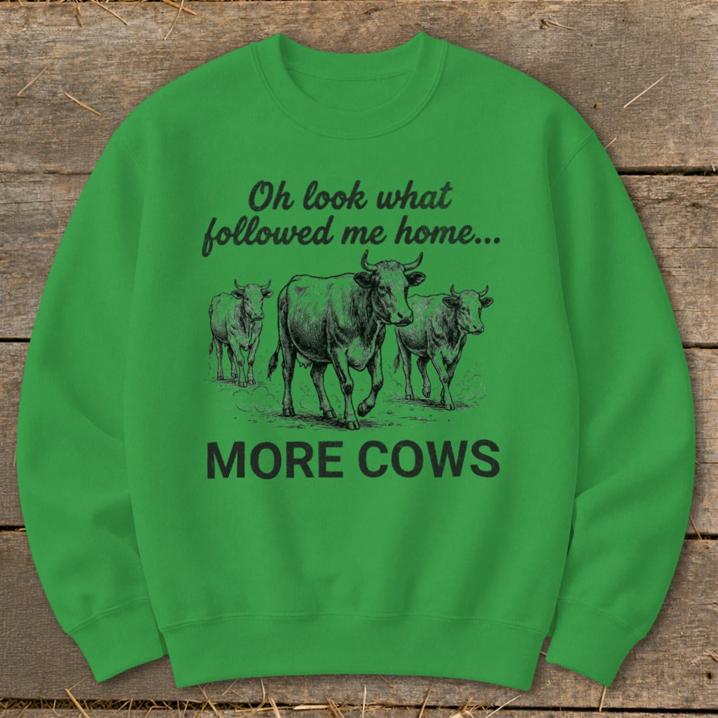 Green sweatshirt with three cows and text "Oh look what followed me home... MORE COWS".