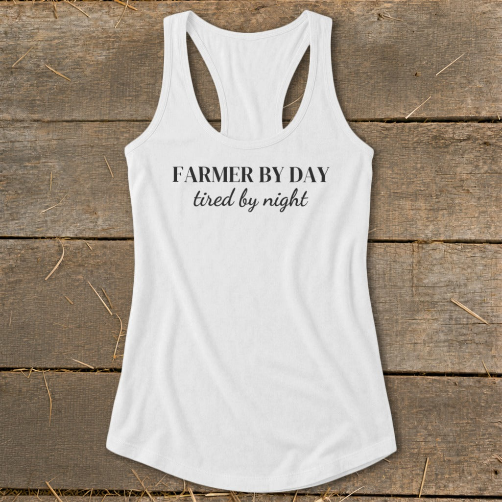 White racerback tank top with text "Farmer by day, tired by night".