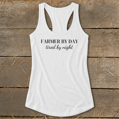 White racerback tank top with text "Farmer by day, tired by night".