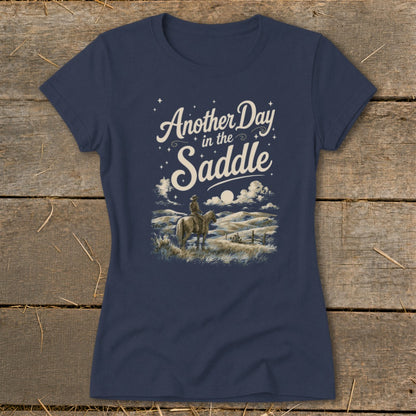 Navy t-shirt graphic with cowboy on horseback and text "Another Day in the Saddle."