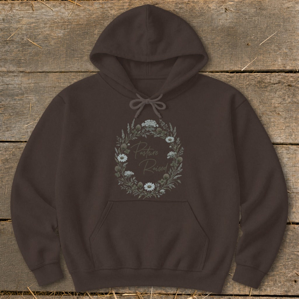 Brown hoodie with a floral wreath design and "Pasture Raised" text.
