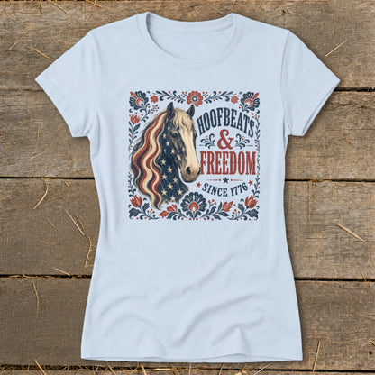Light blue t-shirt with a horse wearing an American flag mane and "Hoofbeats & Freedom Since 1776" text.