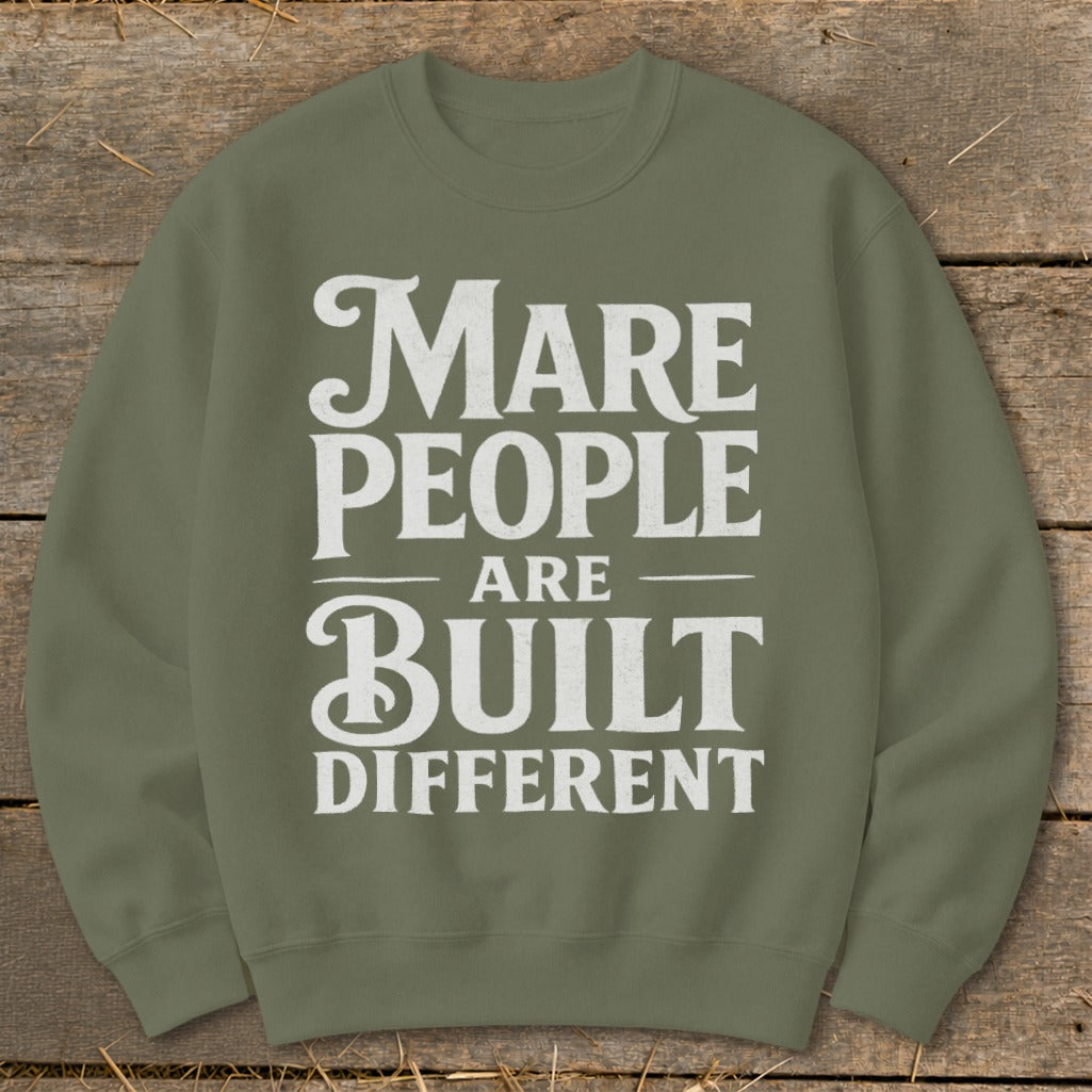Olive green sweatshirt with white text "Mare people are built different".