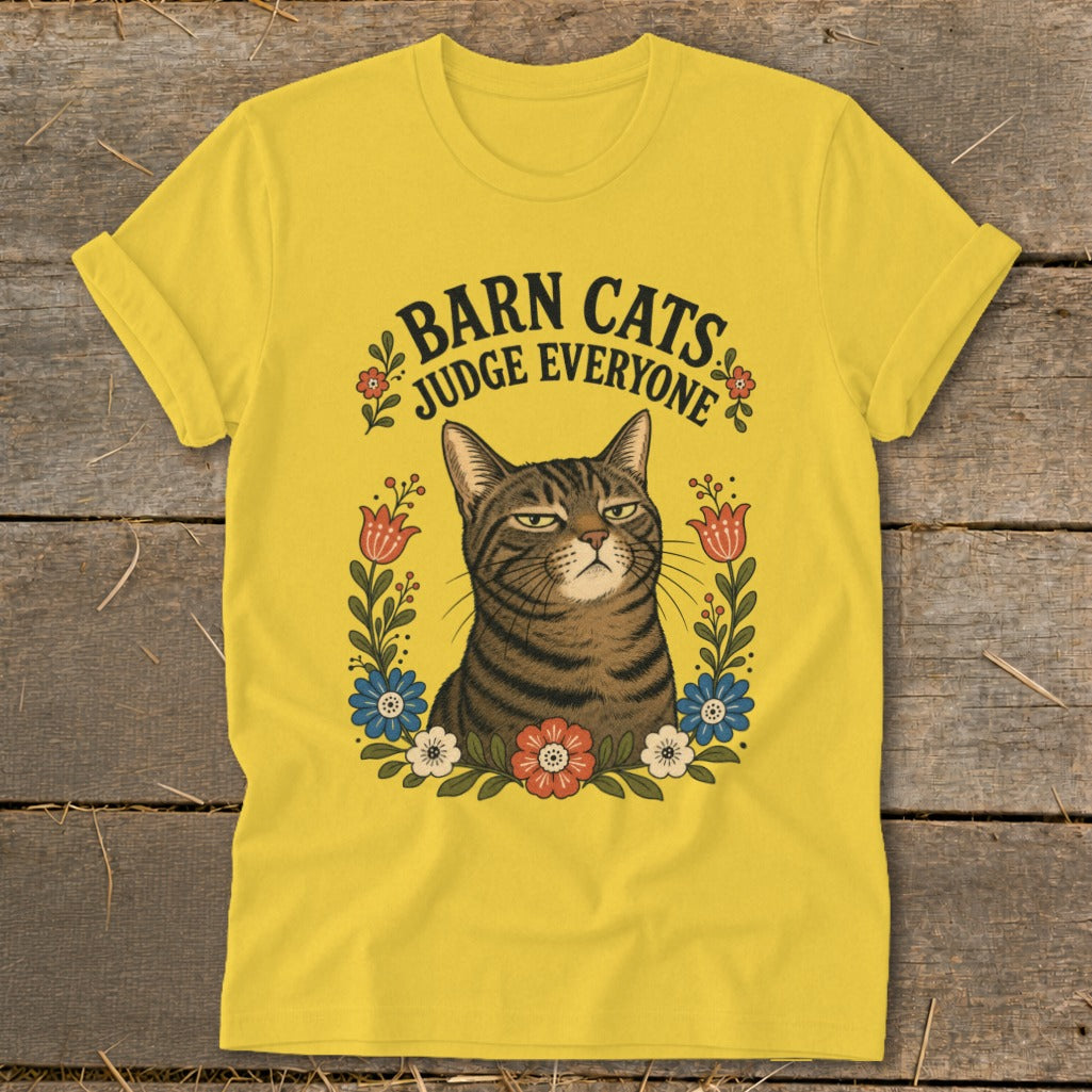 Yellow t-shirt with a tabby cat illustration and the text "BARN CATS JUDGE EVERYONE".