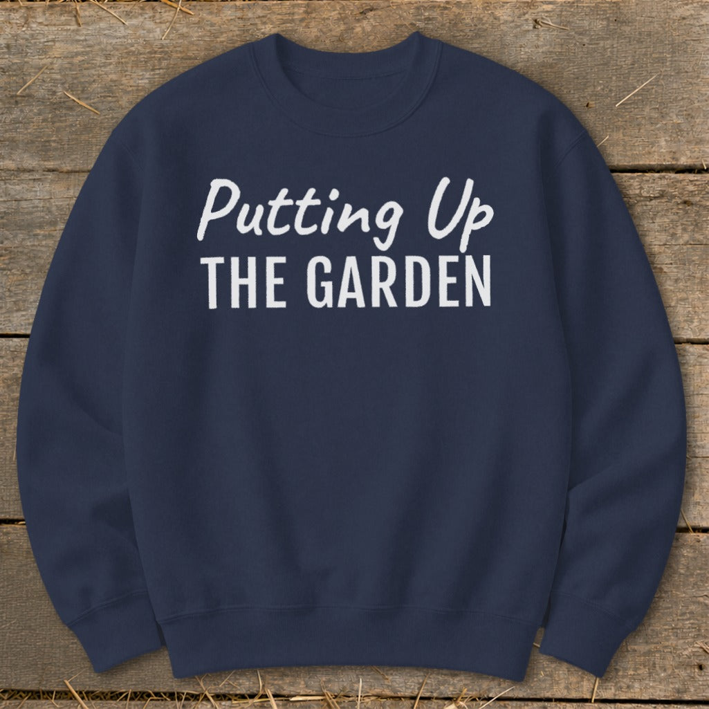Navy sweatshirt with white text "Putting Up THE GARDEN"