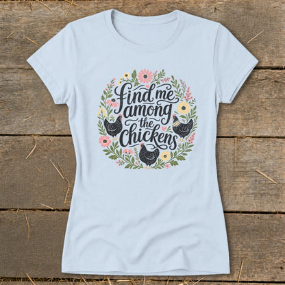 Light blue t-shirt with a floral wreath design and the text "Find me among the chickens".